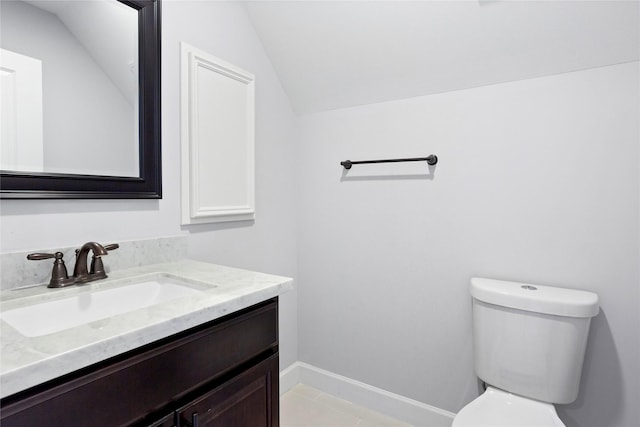 904 W 20th St Unit C, Houston, TX 77008 - bathroom featuring toilet, vanity, vaulted ceiling, tile patterned flooring, and baseboards