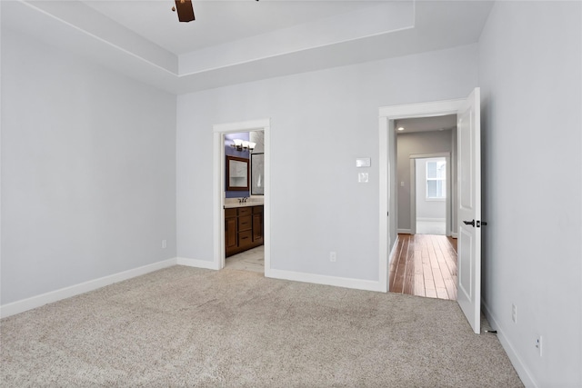 904 W 20th St Unit C, Houston, TX 77008 - unfurnished bedroom with light colored carpet, baseboards, a raised ceiling, and connected bathroom