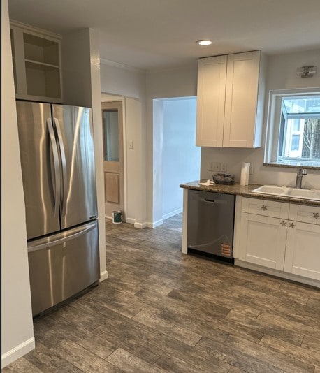 3831 Linklea Dr, Houston, TX 77025 - kitchen featuring appliances with stainless steel finishes, a sink, white cabinets, dark wood-type flooring, and recessed lighting