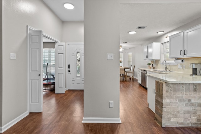 8610 Venture Ln, La Porte, TX 77571 - kitchen with a sink, dishwasher, light countertops, and dark wood-style floors