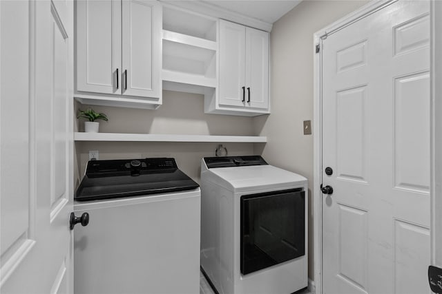 8610 Venture Ln, La Porte, TX 77571 - laundry area featuring independent washer and dryer and cabinet space