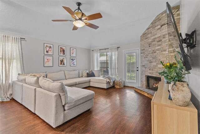 8610 Venture Ln, La Porte, TX 77571 - living room with wood finished floors, a ceiling fan, vaulted ceiling, and a brick fireplace