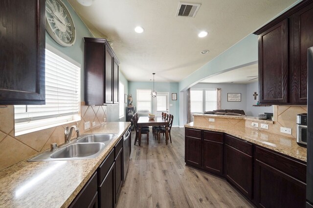 28935 Hidden Cove Dr, Magnolia, TX 77354 - kitchen with a sink, light wood-type flooring, backsplash, dark brown cabinets, and recessed lighting