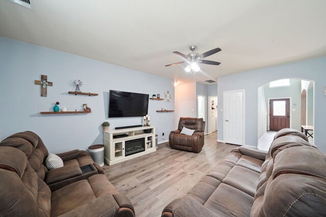 28935 Hidden Cove Dr, Magnolia, TX 77354 - living area featuring arched walkways, a ceiling fan, wood finished floors, and baseboards