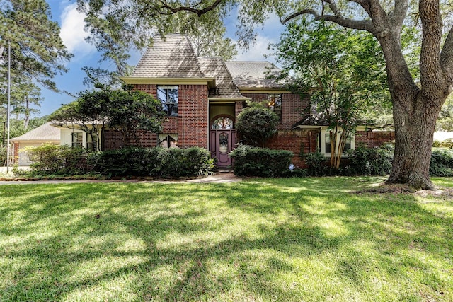 6225 Morton Rd, Katy, TX 77493 - tudor house featuring brick siding, a front lawn, and a shingled roof