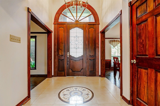 6225 Morton Rd, Katy, TX 77493 - entrance foyer with light tile patterned floors, a chandelier, a towering ceiling, and baseboards