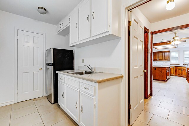 6225 Morton Rd, Katy, TX 77493 - kitchen featuring a sink, freestanding refrigerator, light tile patterned flooring, ceiling fan, and light countertops