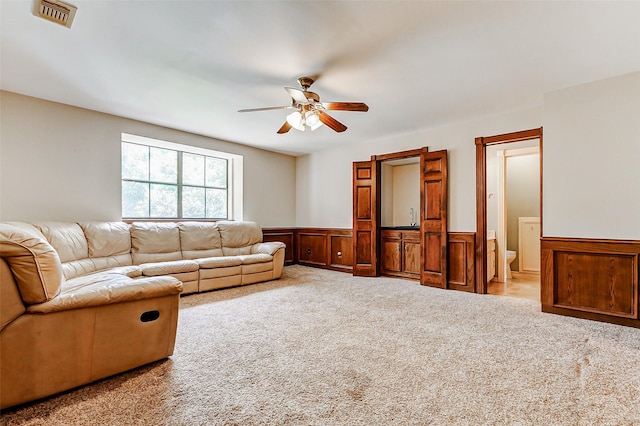 6225 Morton Rd, Katy, TX 77493 - carpeted living room with wainscoting and a ceiling fan