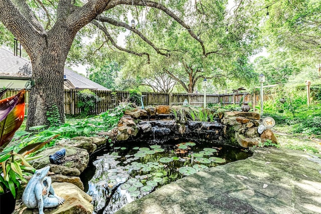 6225 Morton Rd, Katy, TX 77493 - fenced backyard featuring a small pond