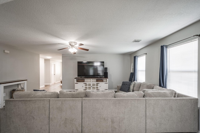 17307 Morning Star Ave, Crosby, TX 77532 - living room with ceiling fan, baseboards, and a textured ceiling