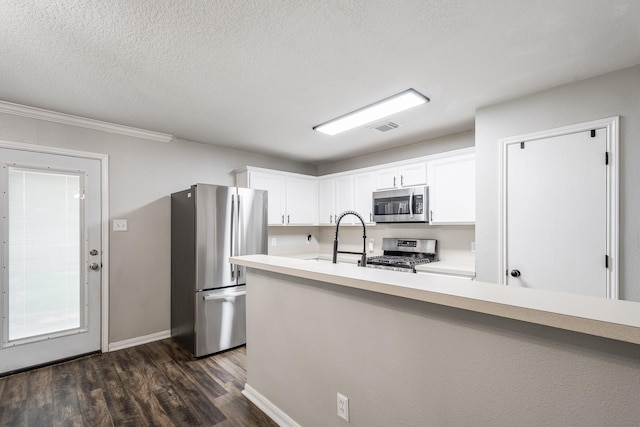 17307 Morning Star Ave, Crosby, TX 77532 - kitchen featuring stainless steel appliances, light countertops, dark wood-style floors, white cabinetry, and baseboards