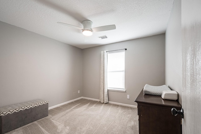 17307 Morning Star Ave, Crosby, TX 77532 - living area featuring light carpet, baseboards, ceiling fan, and a textured ceiling