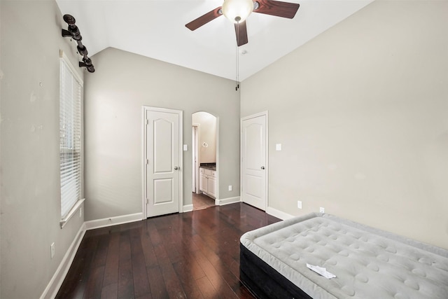 2718 Van Gogh Ln, Missouri City, TX 77459 - unfurnished bedroom with arched walkways, baseboards, dark wood-style floors, vaulted ceiling, and a ceiling fan