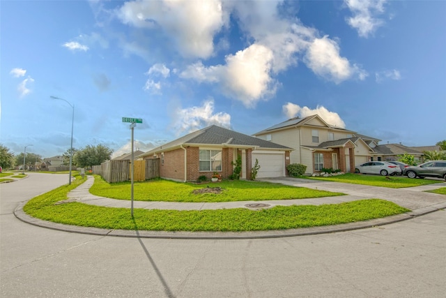 21734 Oriole Trl, Humble, TX 77338 - view of front of house featuring an attached garage, driveway, and brick siding