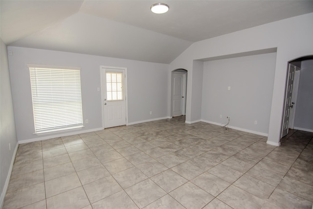 21734 Oriole Trl, Humble, TX 77338 - spare room featuring lofted ceiling, arched walkways, and baseboards
