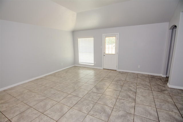 21734 Oriole Trl, Humble, TX 77338 - unfurnished room featuring light tile patterned floors, vaulted ceiling, and baseboards