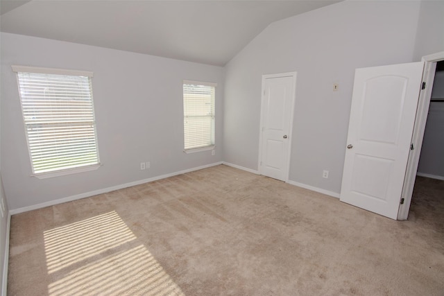 21734 Oriole Trl, Humble, TX 77338 - unfurnished bedroom featuring lofted ceiling, carpet, and baseboards