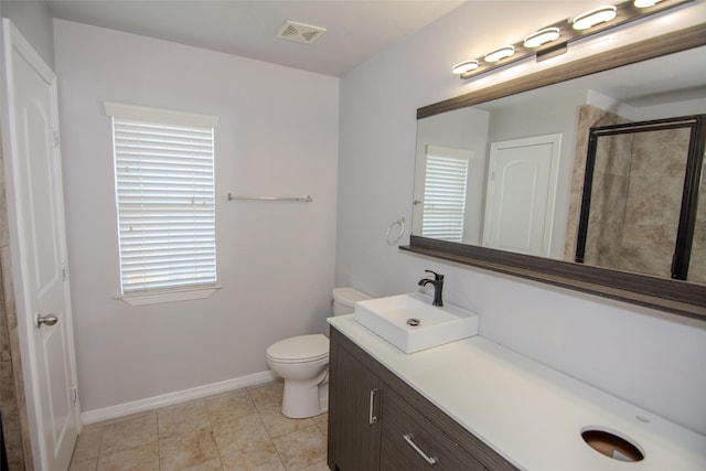 21734 Oriole Trl, Humble, TX 77338 - bathroom featuring vanity, toilet, tiled shower, baseboards, and tile patterned flooring