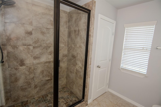 21734 Oriole Trl, Humble, TX 77338 - bathroom featuring a shower stall, baseboards, and tile patterned flooring