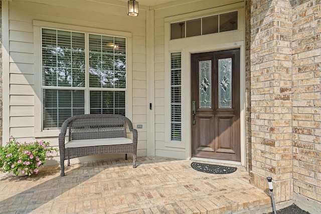6219 Royal Hollow Ln, Katy, TX 77450 - doorway to property featuring covered porch and brick siding