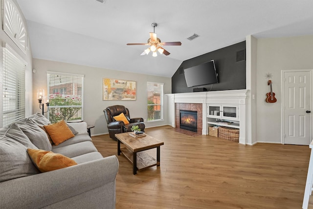 6219 Royal Hollow Ln, Katy, TX 77450 - living area with ceiling fan, healthy amount of natural light, vaulted ceiling, light wood-style flooring, and a tile fireplace