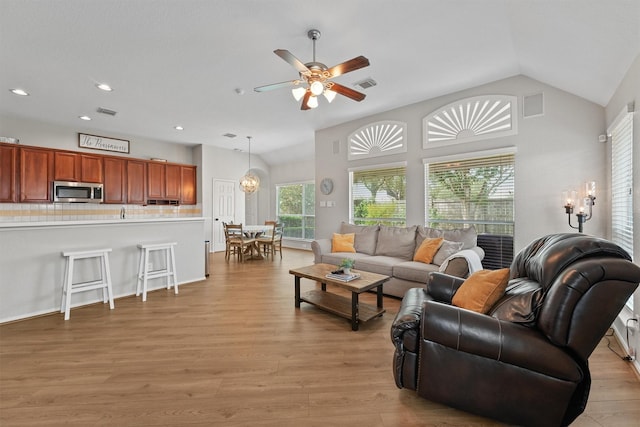 6219 Royal Hollow Ln, Katy, TX 77450 - living area with vaulted ceiling, light wood-type flooring, ceiling fan, recessed lighting, and a chandelier