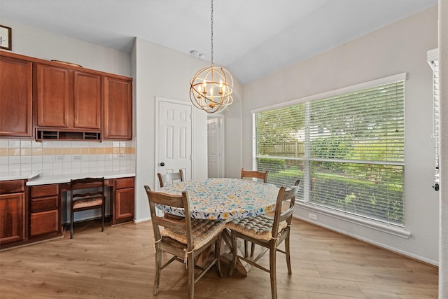 6219 Royal Hollow Ln, Katy, TX 77450 - dining area featuring a chandelier, lofted ceiling, and light wood-style floors