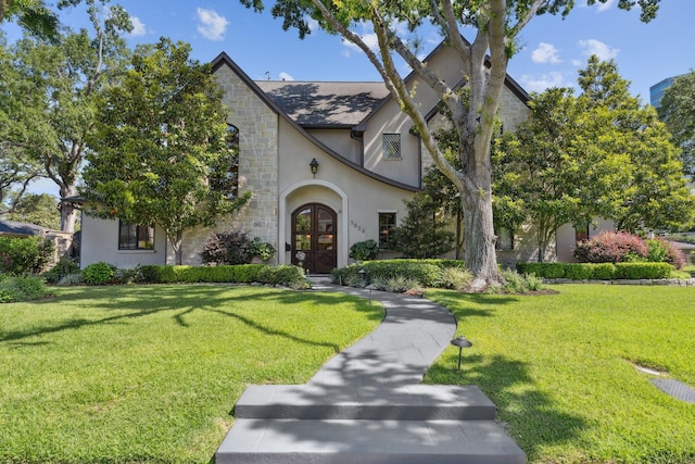 5626 Willers Way, Houston, TX 77056 - tudor house featuring french doors, stone siding, stucco siding, and a front yard