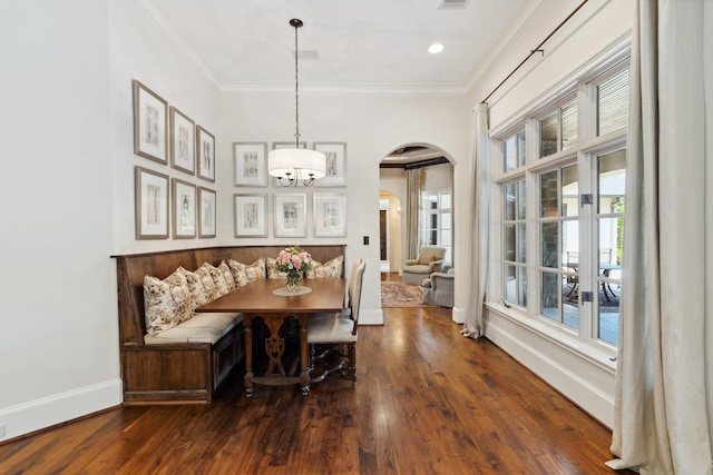 5626 Willers Way, Houston, TX 77056 - dining room featuring arched walkways, wood finished floors, baseboards, healthy amount of natural light, and crown molding