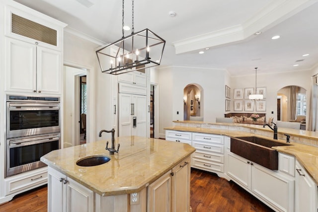 5626 Willers Way, Houston, TX 77056 - kitchen with arched walkways, a sink, stainless steel double oven, crown molding, and recessed lighting