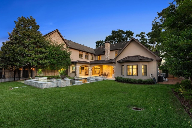 5626 Willers Way, Houston, TX 77056 - back of property with stucco siding, a chimney, a standing seam roof, and metal roof