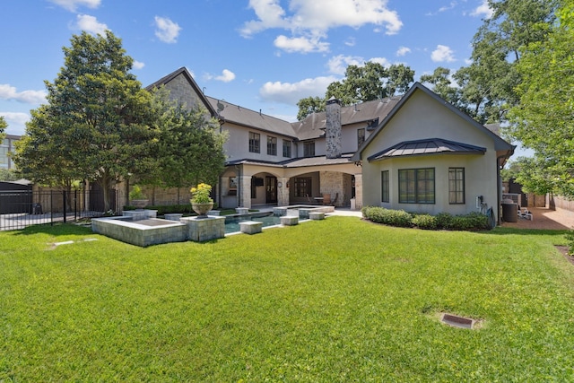 5626 Willers Way, Houston, TX 77056 - back of house with stucco siding, a standing seam roof, stone siding, metal roof, and a patio