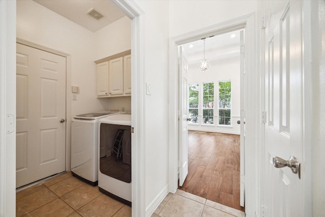 12210 Pebble Mdws, Houston, TX 77041 - laundry area featuring cabinet space, independent washer and dryer, light tile patterned floors, and baseboards