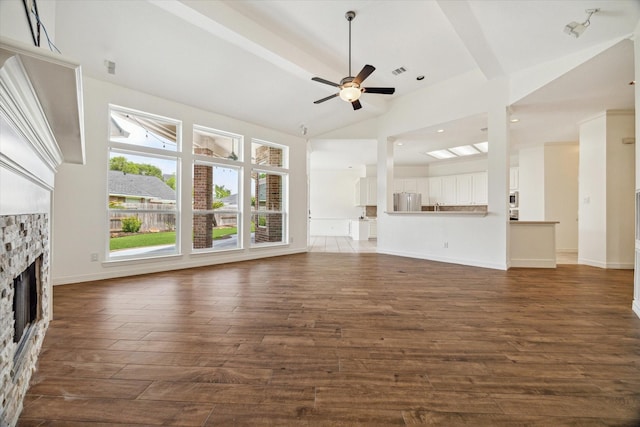 12210 Pebble Mdws, Houston, TX 77041 - unfurnished living room featuring a fireplace, dark wood-style flooring, lofted ceiling, a ceiling fan, and baseboards