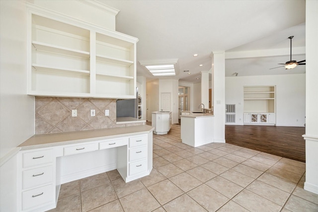 12210 Pebble Mdws, Houston, TX 77041 - kitchen featuring light tile patterned floors, open shelves, open floor plan, a sink, and built in features