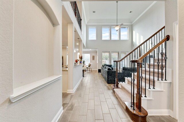 3413 Waverly Springs Ln, Pearland, TX 77581 - entryway with a ceiling fan, baseboards, stairs, ornamental molding, and wood finished floors