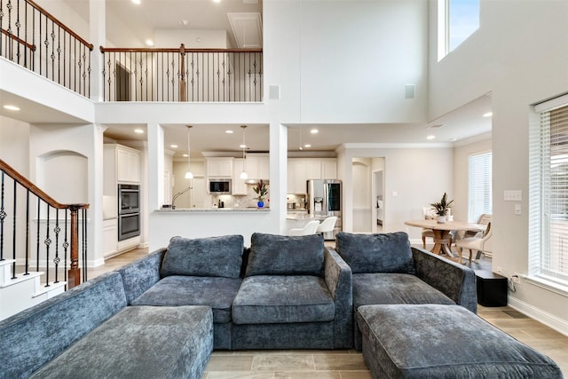 3413 Waverly Springs Ln, Pearland, TX 77581 - living area featuring a towering ceiling, stairs, and baseboards