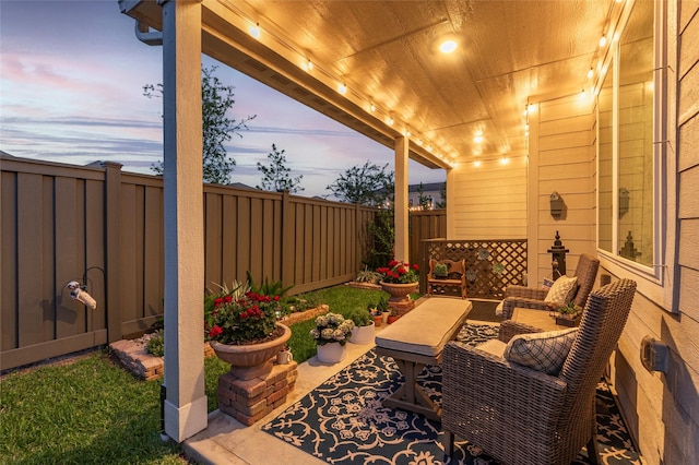 614 Seabreeze Dr, Kemah, TX 77565 - patio terrace at dusk featuring a fenced backyard and outdoor lounge area