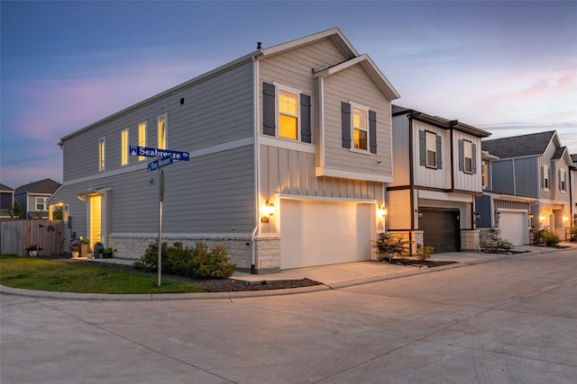 614 Seabreeze Dr, Kemah, TX 77565 - view of front of property with stone siding, a garage, concrete driveway, and board and batten siding