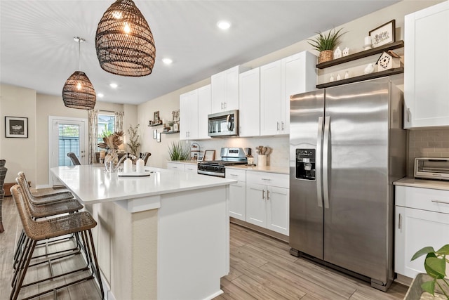 614 Seabreeze Dr, Kemah, TX 77565 - kitchen featuring stainless steel appliances, open shelves, recessed lighting, light countertops, and decorative backsplash