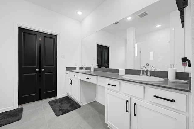 9506 Marble Park Ln, Baytown, TX 77521 - full bath featuring double vanity, tile patterned flooring, a tile shower, and baseboards
