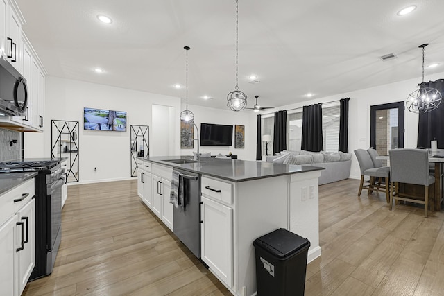 9506 Marble Park Ln, Baytown, TX 77521 - kitchen featuring a chandelier, appliances with stainless steel finishes, dark countertops, a sink, and recessed lighting