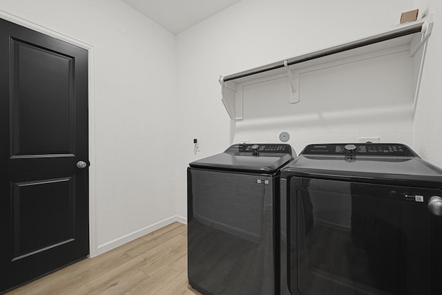 9506 Marble Park Ln, Baytown, TX 77521 - laundry room featuring light wood-type flooring, washing machine and dryer, and baseboards