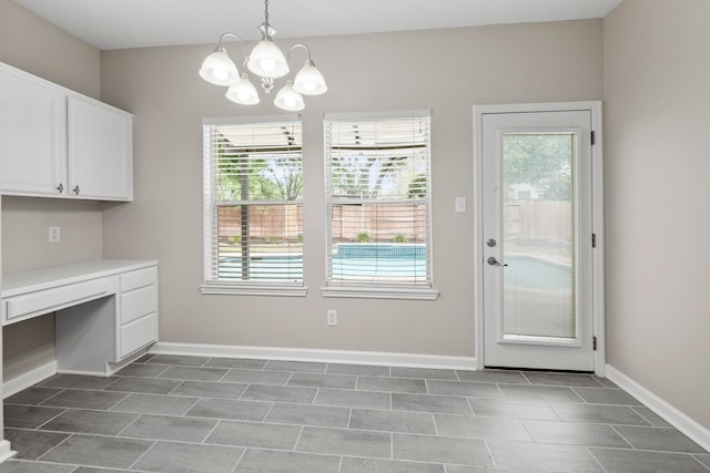 1811 Senca Springs Ct, Katy, TX 77450 - unfurnished dining area featuring healthy amount of natural light, baseboards, and a chandelier