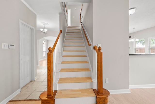 1811 Senca Springs Ct, Katy, TX 77450 - staircase with arched walkways, a chandelier, baseboards, wood finished floors, and ornamental molding