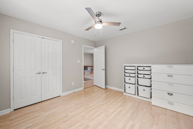 1811 Senca Springs Ct, Katy, TX 77450 - unfurnished bedroom with light wood finished floors, baseboards, a closet, and a ceiling fan