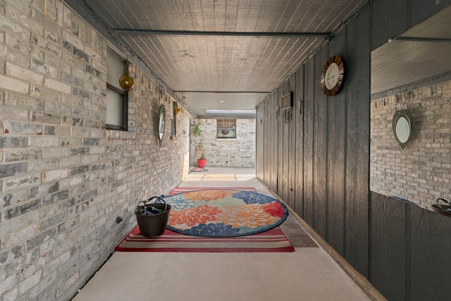 2413 38th Ave N, Texas City, TX 77590 - hall featuring brick wall and finished concrete flooring