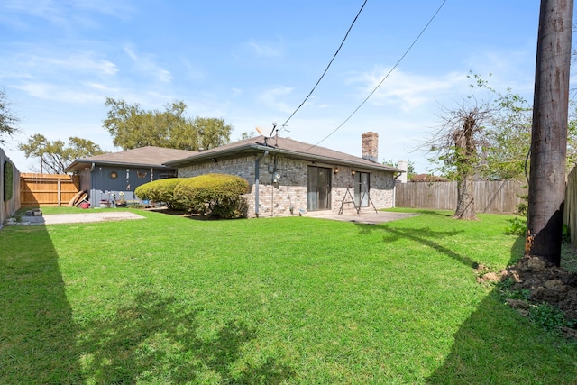 2413 38th Ave N, Texas City, TX 77590 - rear view of house featuring a chimney, a patio, and brick siding