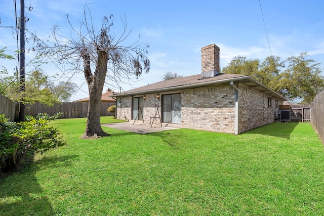 2413 38th Ave N, Texas City, TX 77590 - rear view of property featuring a chimney, central AC, brick siding, and a patio area