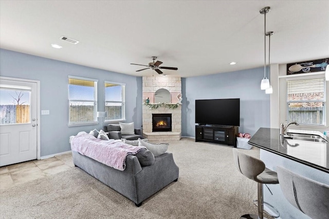 2506 Solitude, Deer Park, TX 77536 - carpeted living area featuring a sink, ceiling fan, a fireplace, baseboards, and recessed lighting